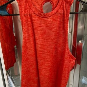 Size 4 lululemon cropped X back tank in red/orng. Loose, long front, short back
